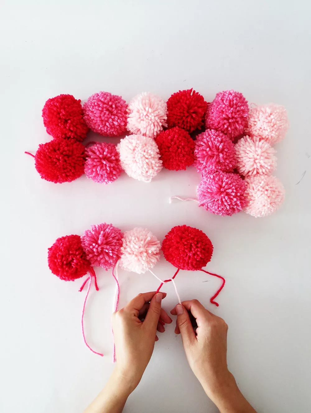 putting the pom poms scarf together