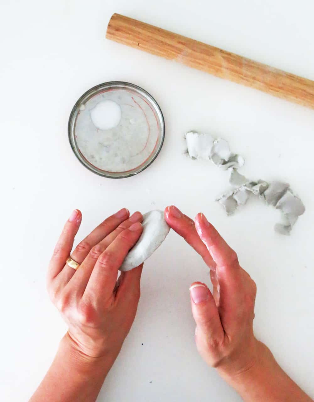 smooth the clay on the glass jar lid