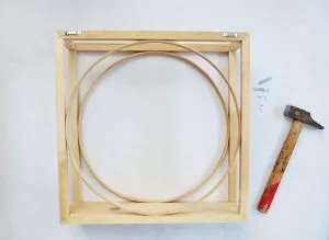 An easy DIY to build a geometric display shelf using embroidery loops and wood trim. #diyshelf #storage #displayshelf #wallshelf #homedecor #diy