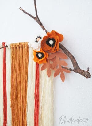 DIY yarn wall hanging with felt flowers