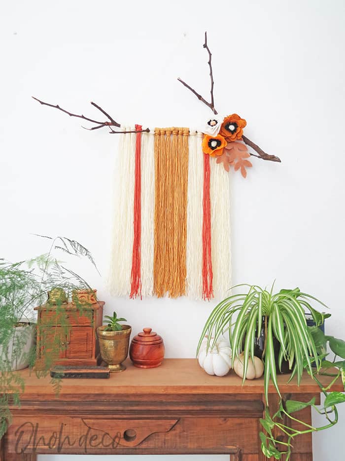 DIY yarn wall hanging with felt flowers