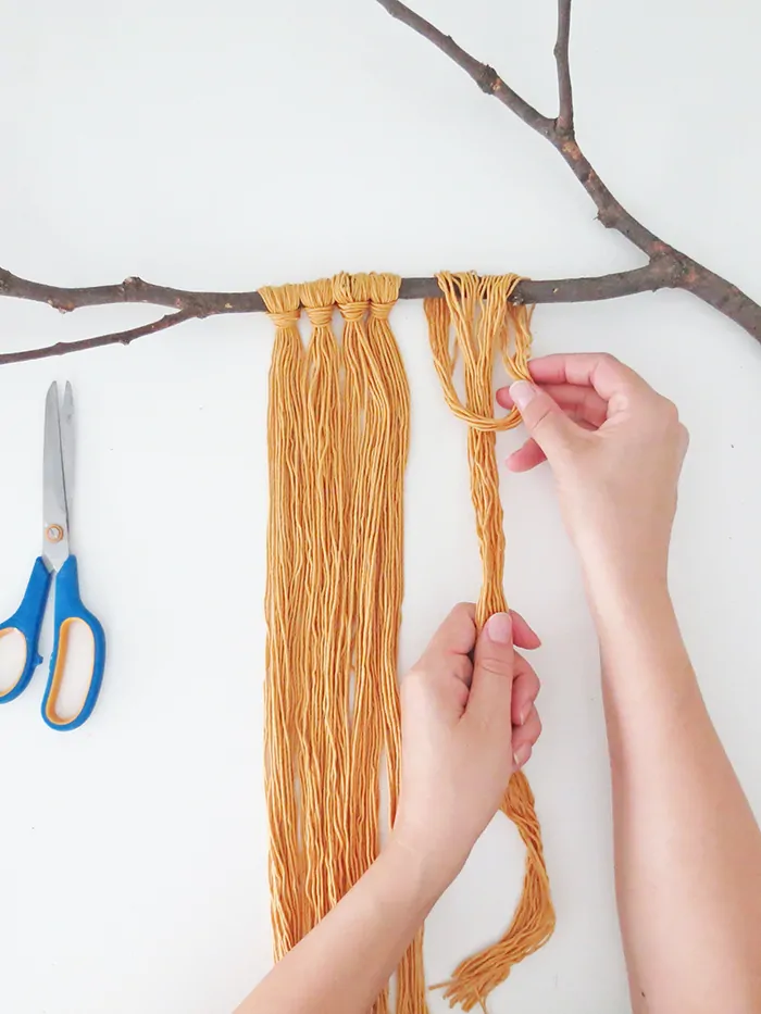 DIY yarn wall hanging with felt flowers