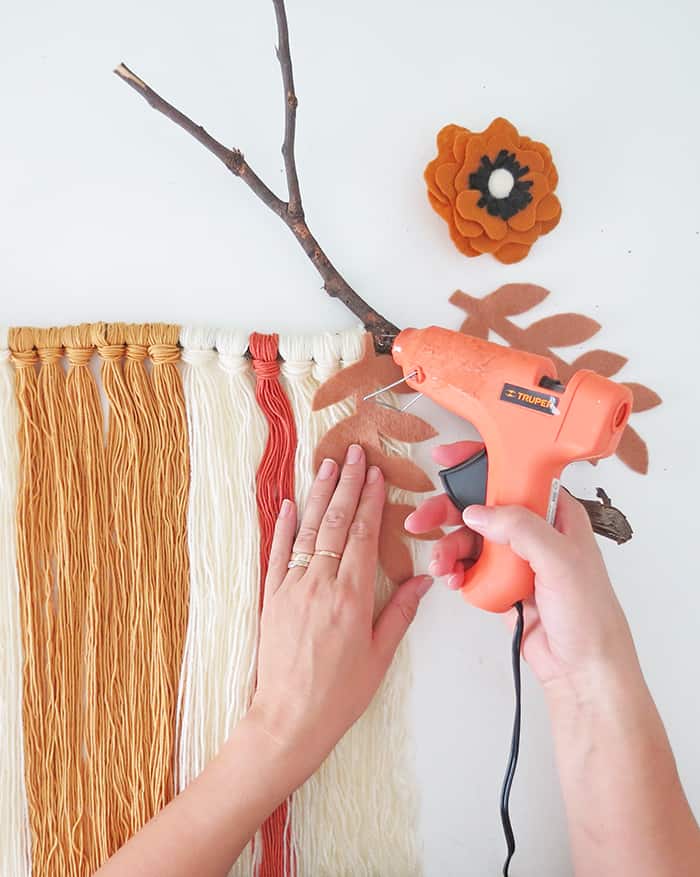 DIY yarn wall hanging with felt flowers