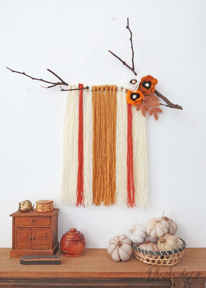 DIY yarn wall hanging with felt flowers