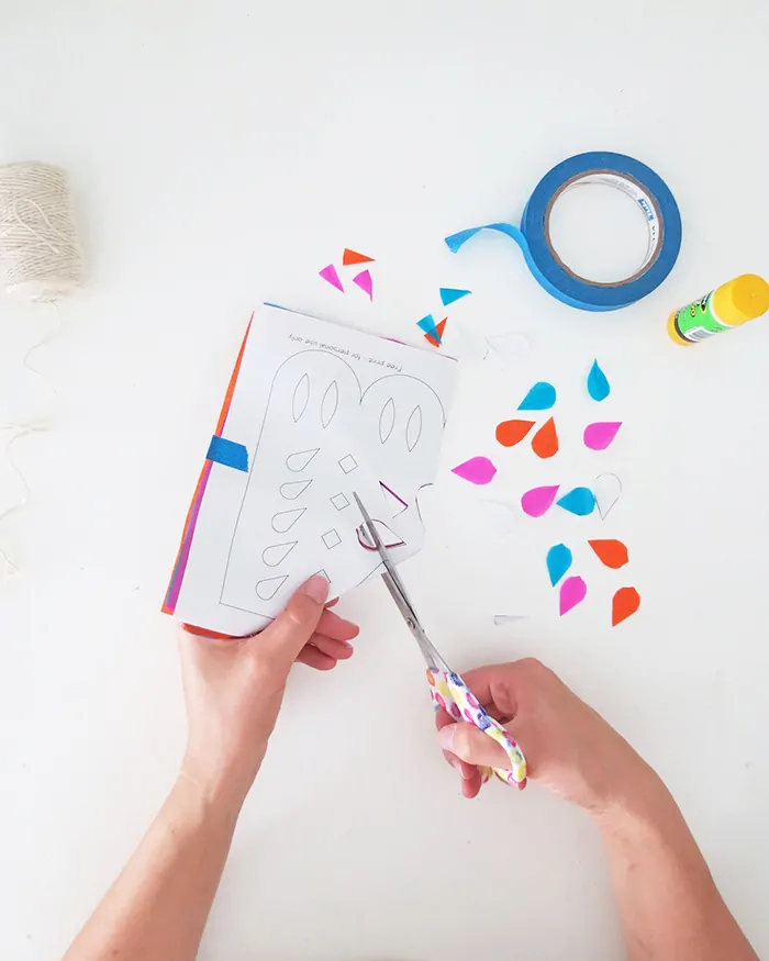 how to make diy papel picado cutting the paper