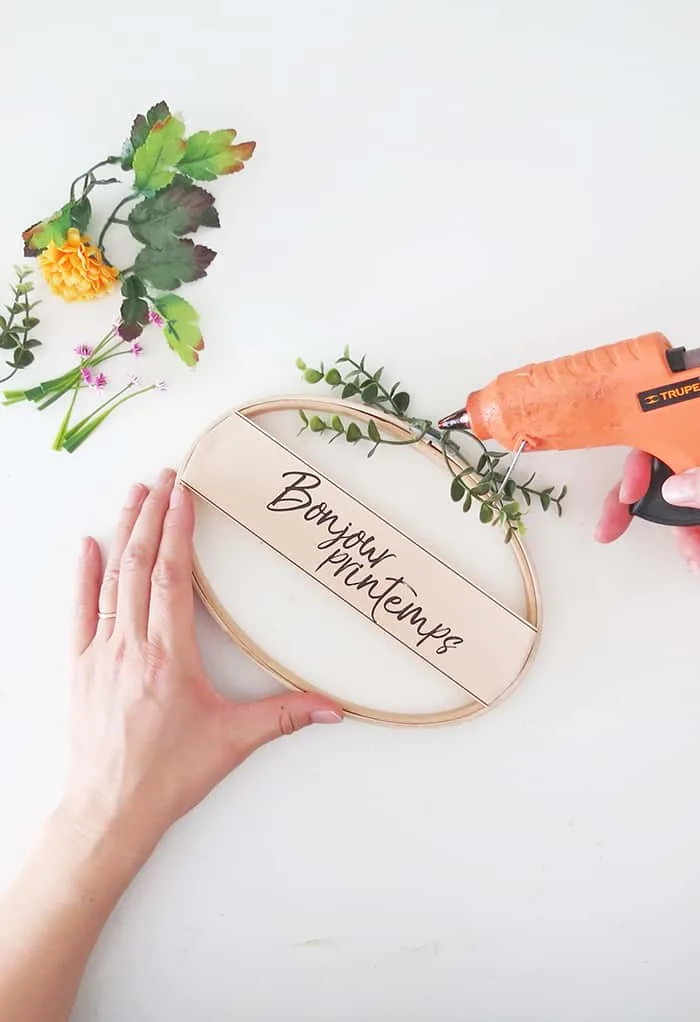 gluing foliage on spring wreath