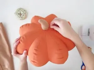 sew the stem on the pumpkin shaped pillow