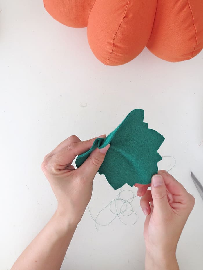 fold and sew the leaf on the pumpkin pillow
