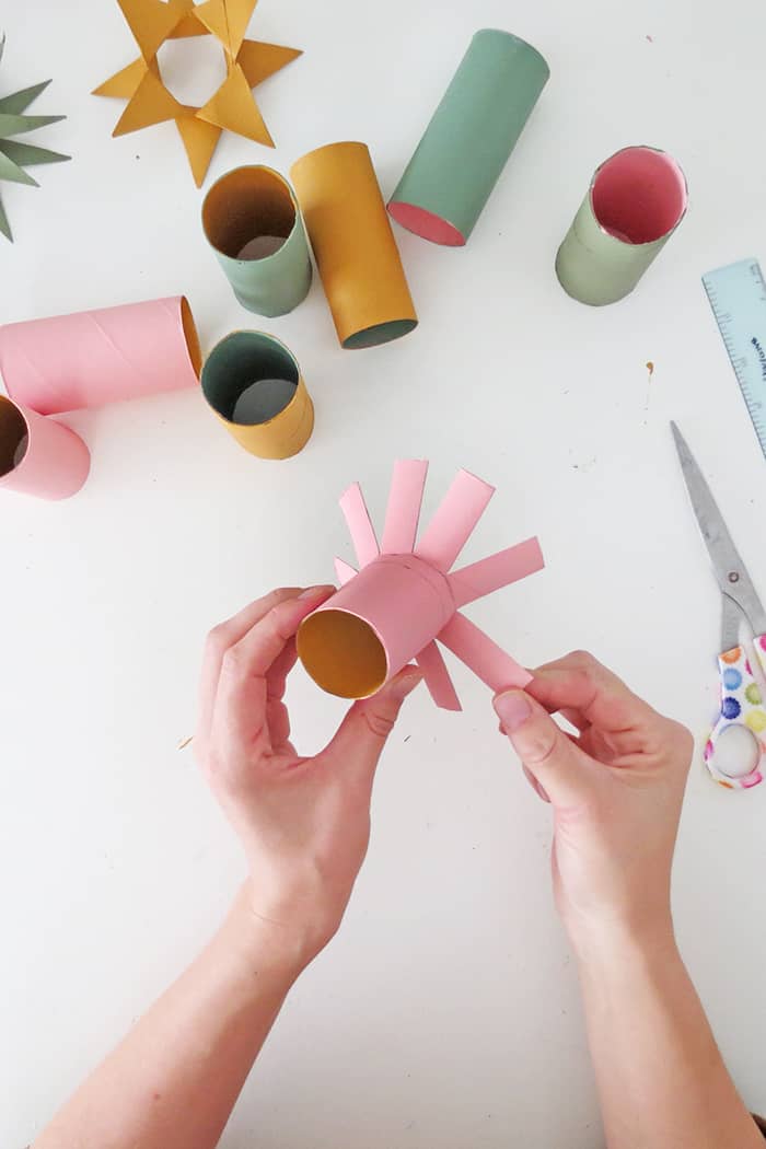 fold straps to make christmas ornament with toilet roll