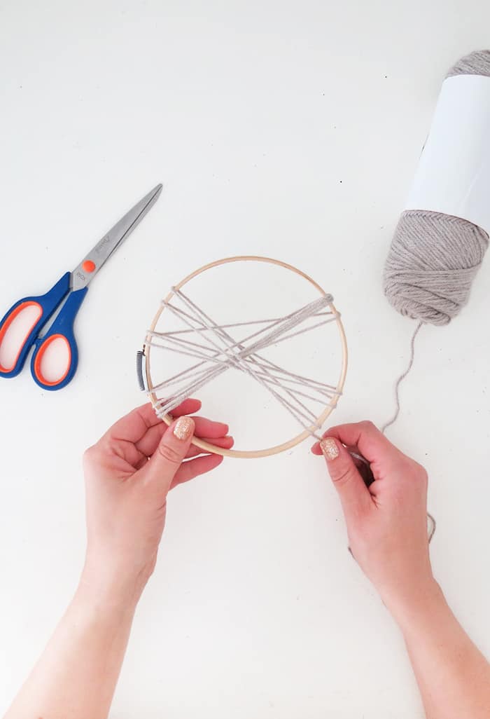 wrap yarn to make a large pom pom