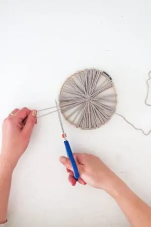 cut the yarn to make giant pom poms