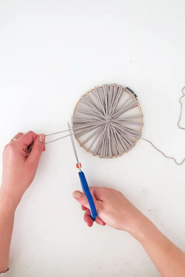 cut the yarn to make giant pom poms