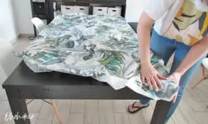 place a fitted tablecloth to cover table