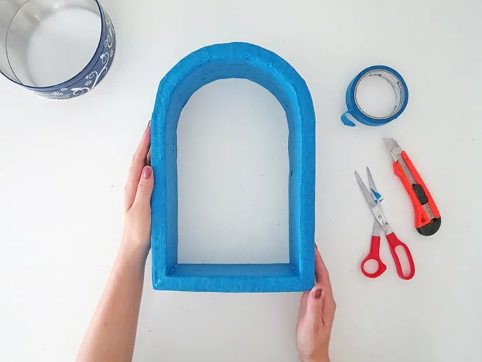 tape the cardboard edges to DIY wall shelf