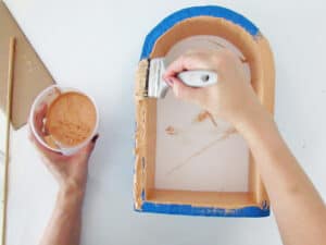 apply paint on add cardboard layers to diy wall shelf