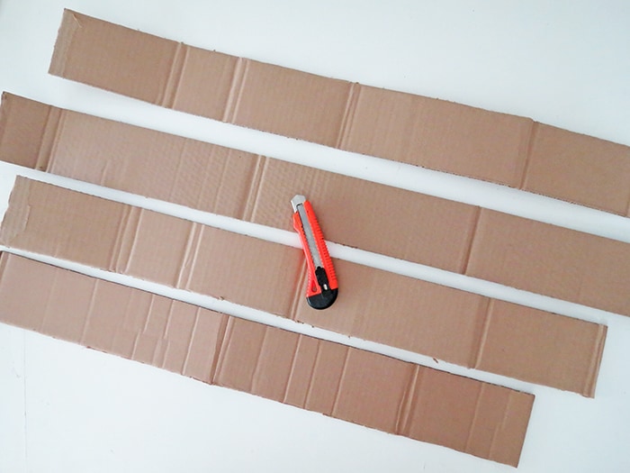 Cut cardboard to make diy wall shelf