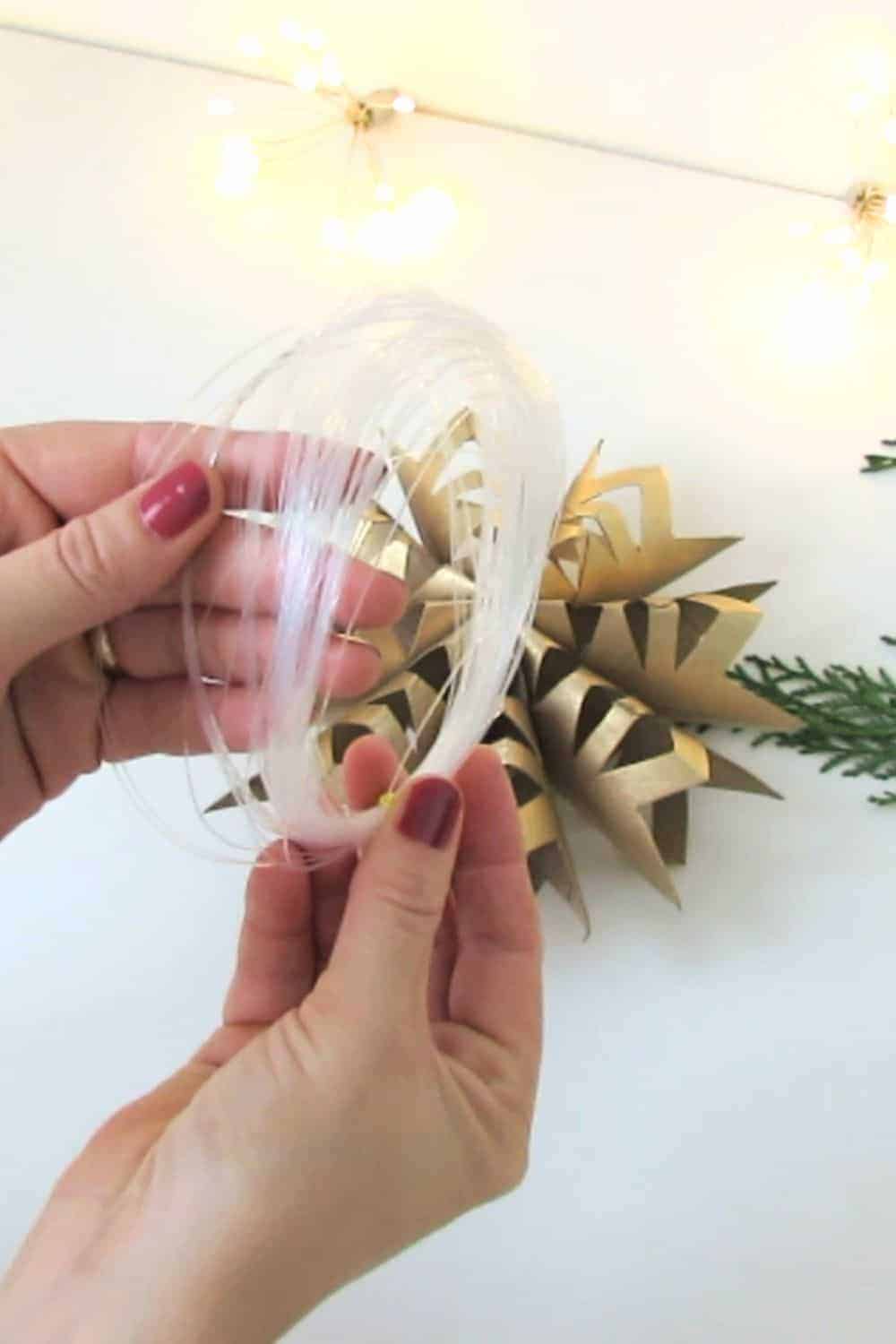 add rope to hang DIY snowflake