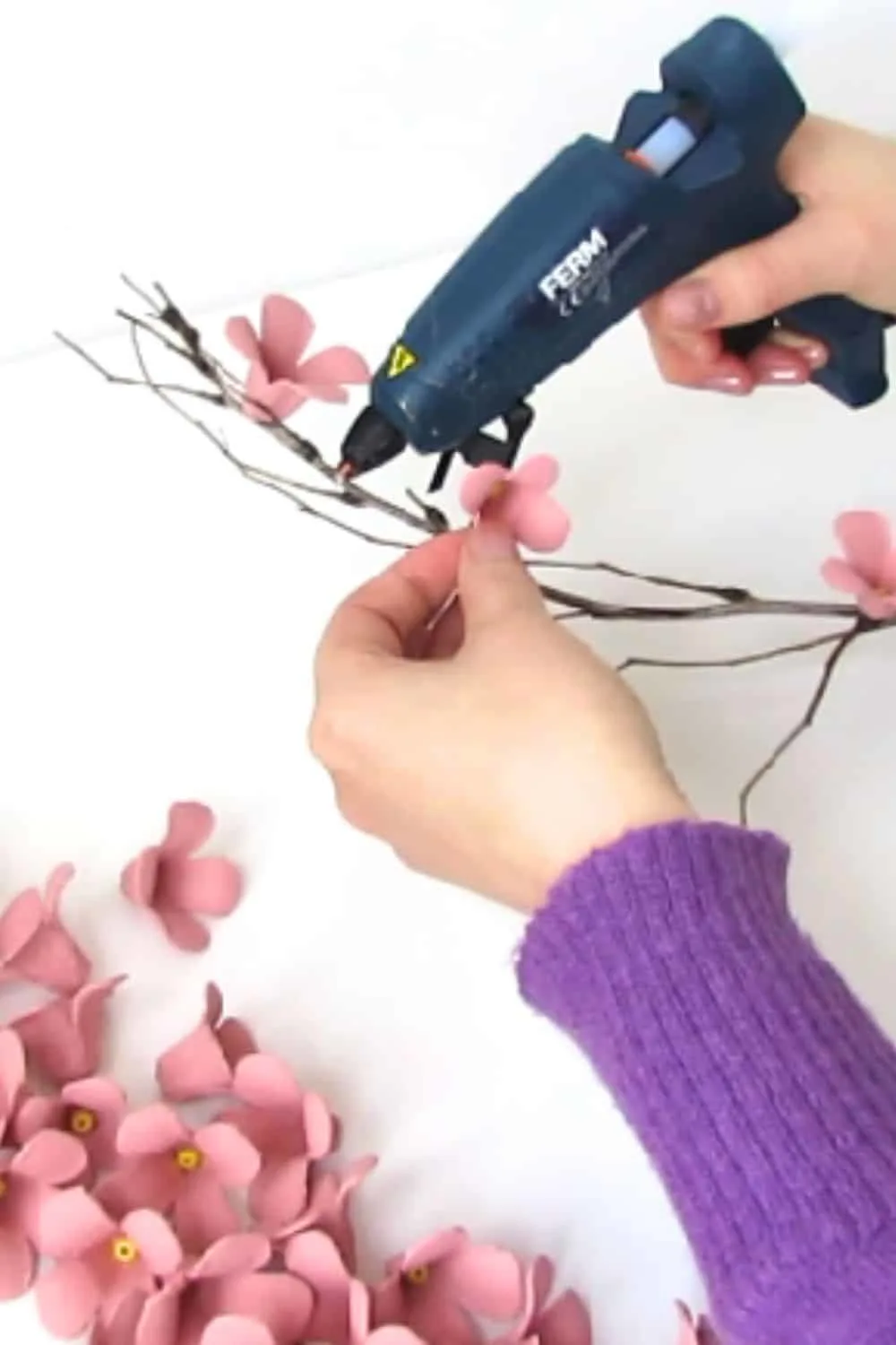 glue the cherry flowers on the tree branches