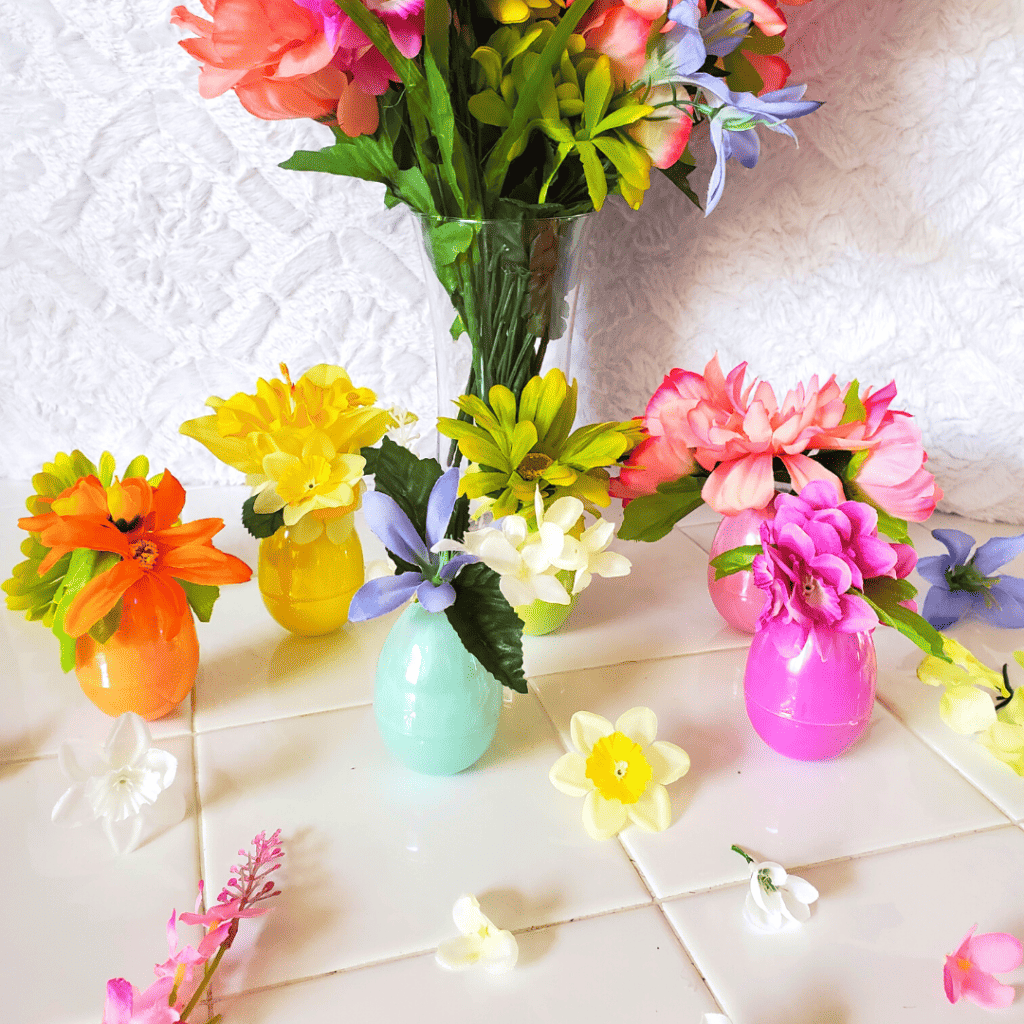 These DIY Flower Egg Vases are the perfect spring decor DIY! With some plastic Easter eggs and faux flowers, your space will blossom for spring!
