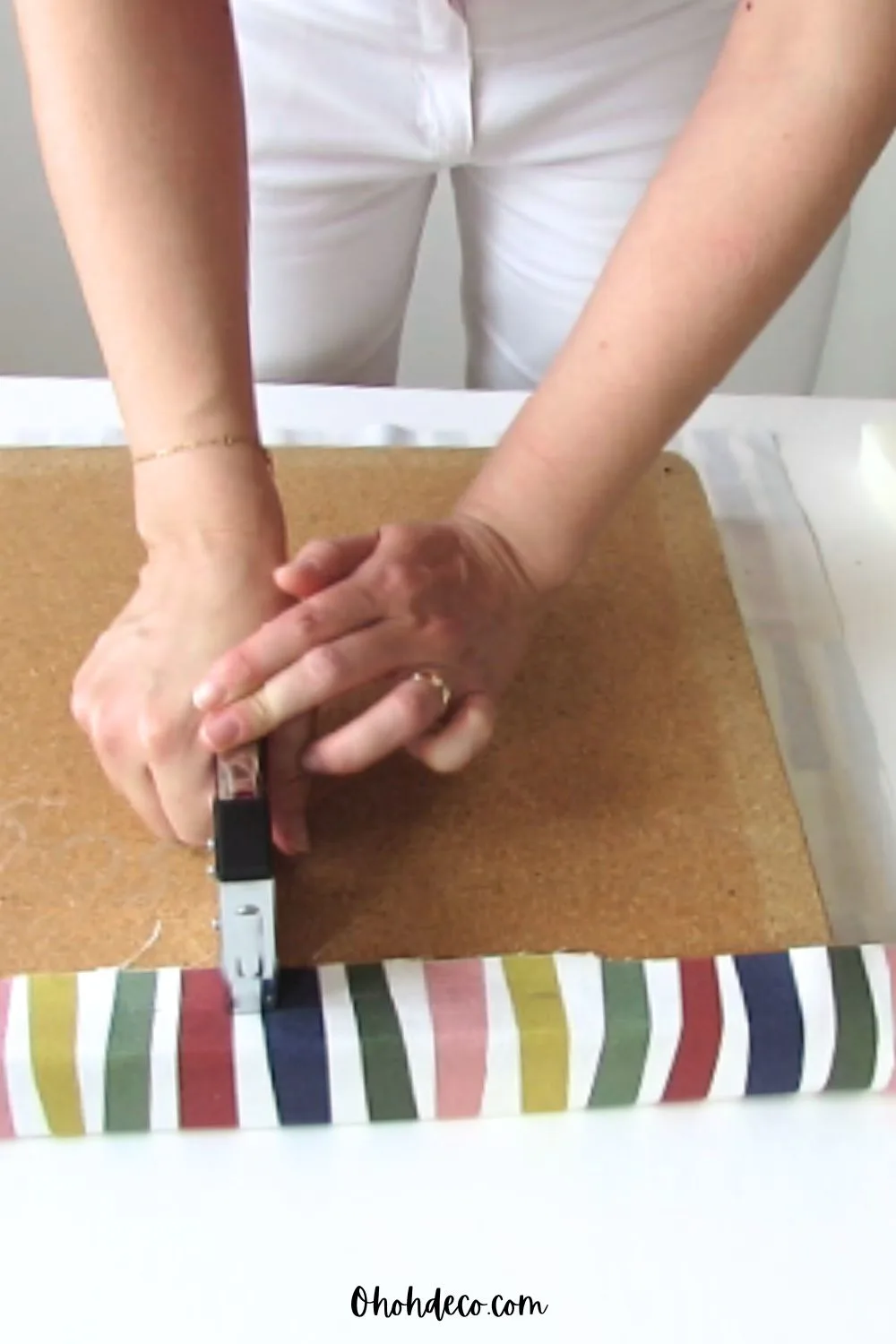 staple the fabric on the chair seat 