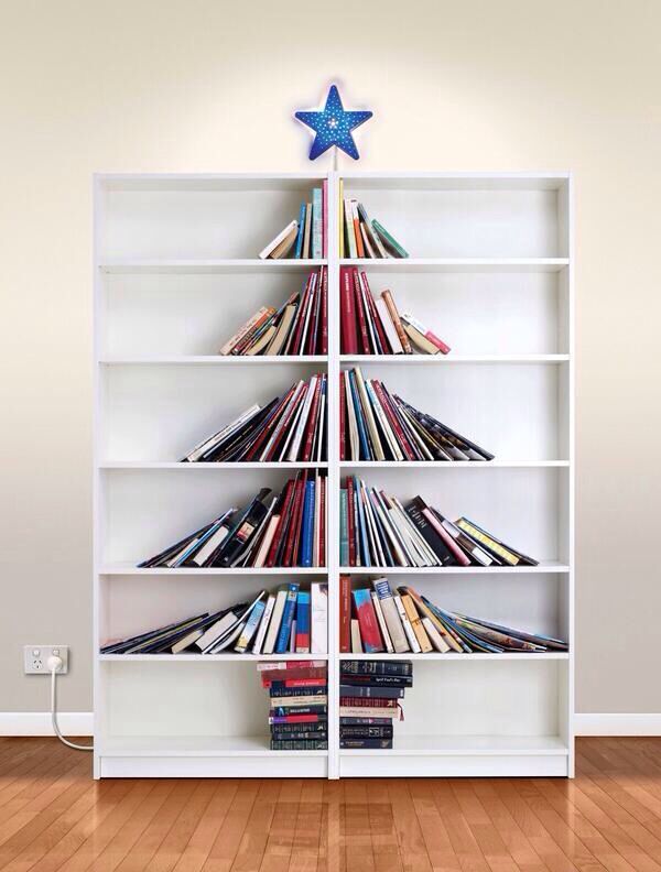This may contain: a white book shelf filled with books on top of a hard wood floor next to a wall