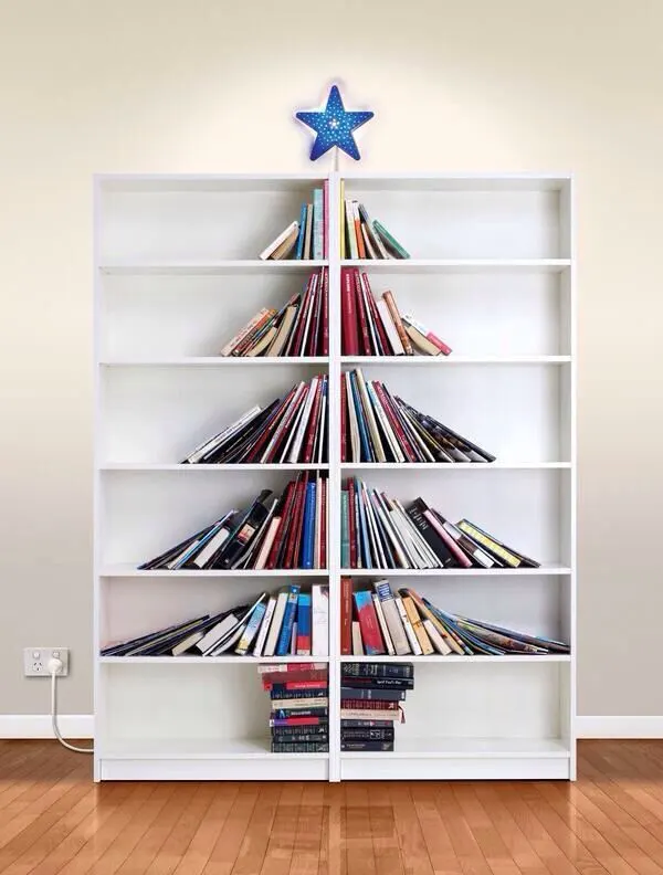 This may contain: a white book shelf filled with books on top of a hard wood floor next to a wall