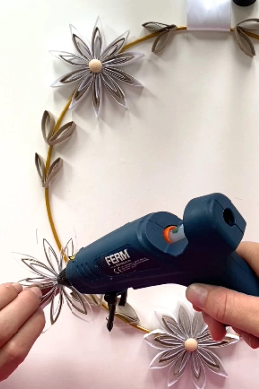 glue flowers and leaf to make the wreath